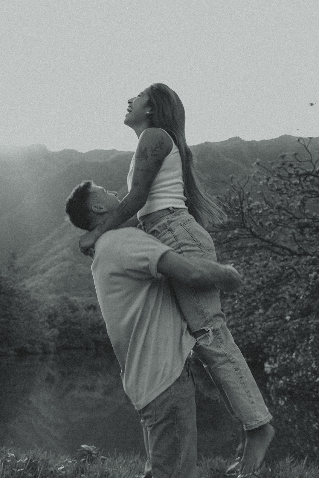 Lush Lakeside Mountains Oahu Hawaii Engagement Pictures Twirling and Dancing Couple North Shore Black and White