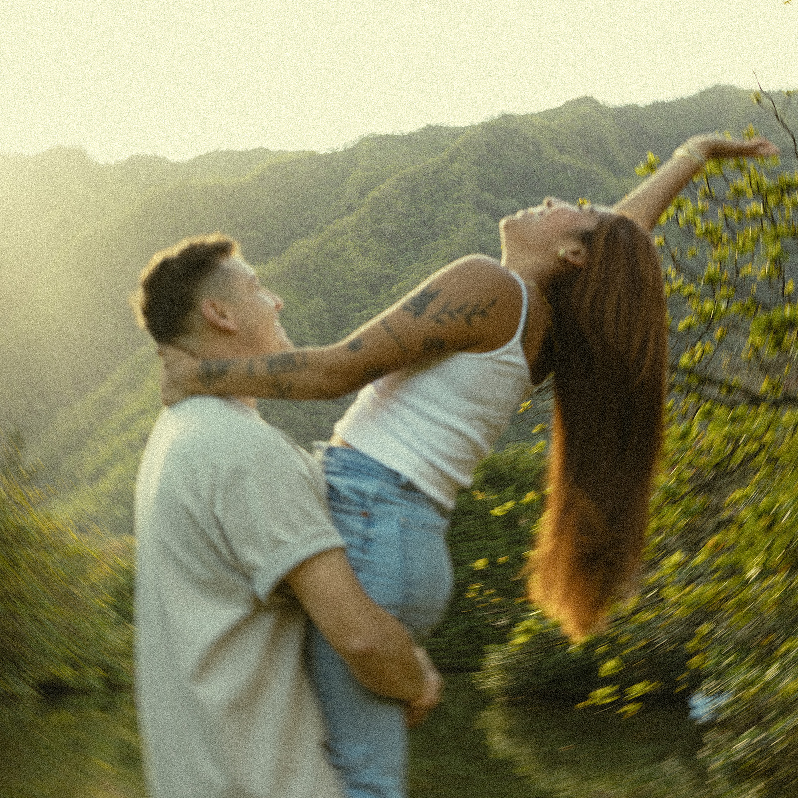 Lush Lakeside Mountains Oahu Hawaii Engagement Pictures Twirling and Dancing Couple North Shore