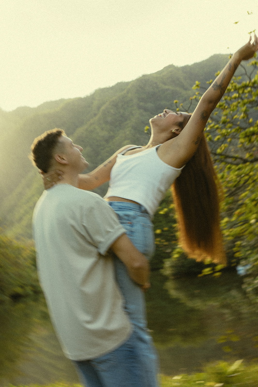 Lush Lakeside Mountains Oahu Hawaii Engagement Pictures Twirling and Dancing Couple North Shore