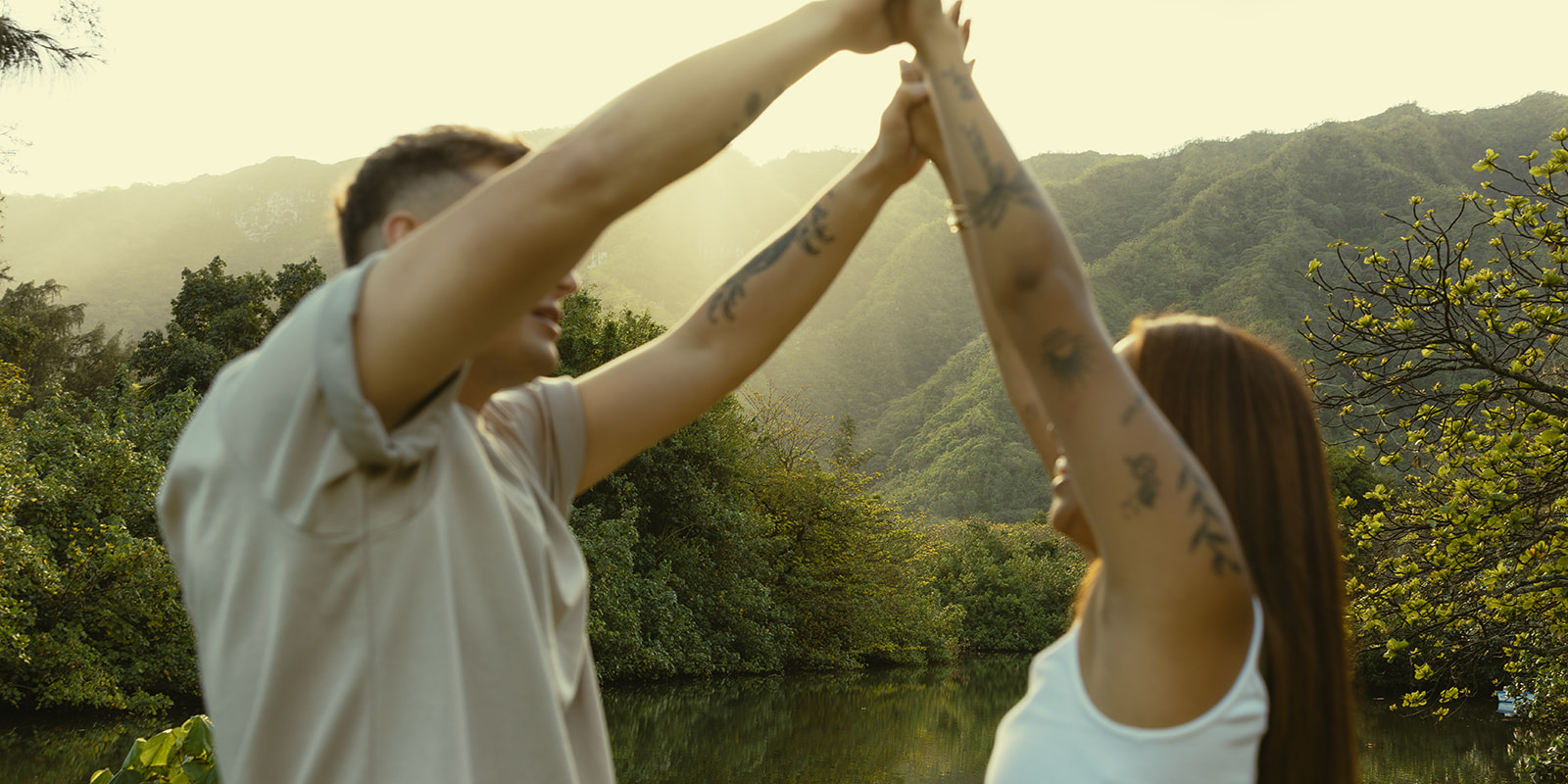 Lush Lakeside Mountains Oahu Hawaii Engagement Pictures Twirling and Dancing Couple North Shore