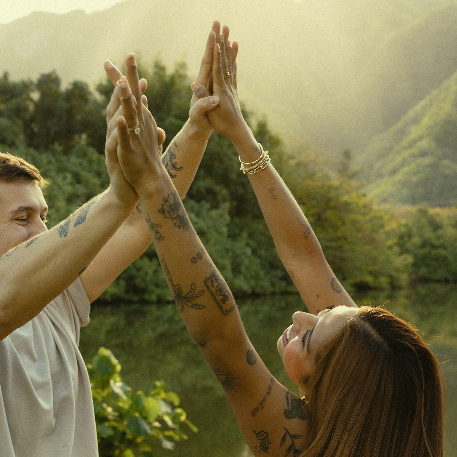 Lush Lakeside Mountains Oahu Hawaii Engagement Pictures Twirling and Dancing Couple North Shore