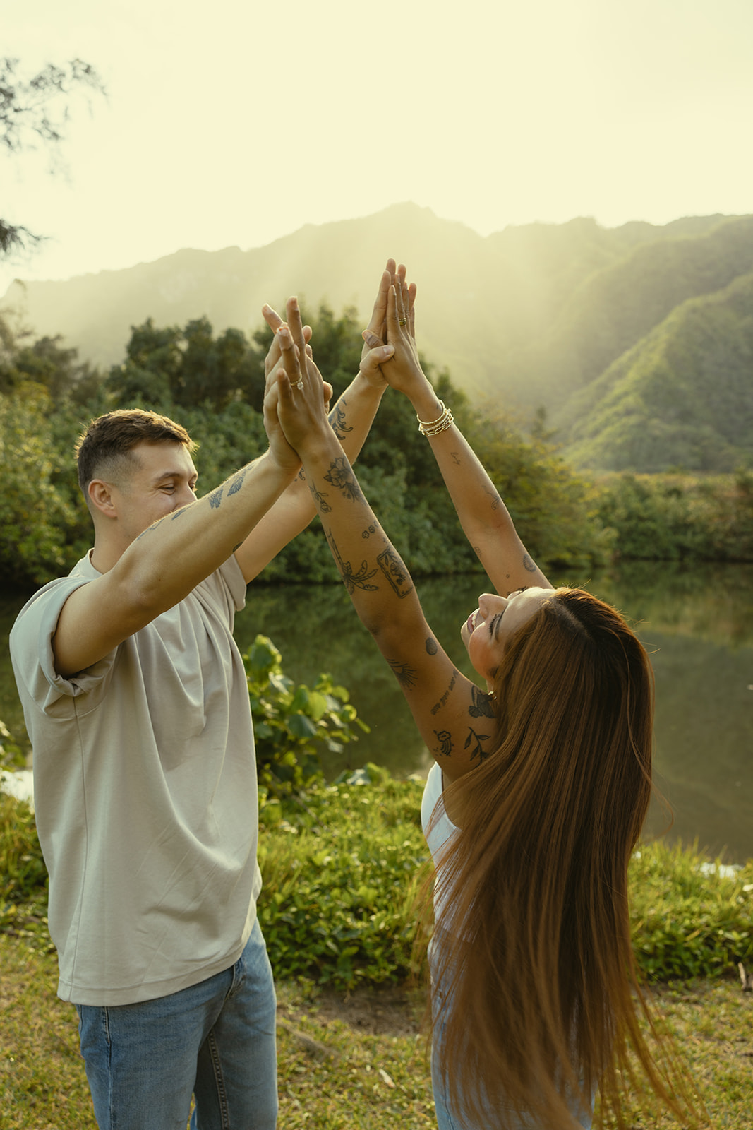 Lush Lakeside Mountains Oahu Hawaii Engagement Pictures Twirling and Dancing Couple North Shore