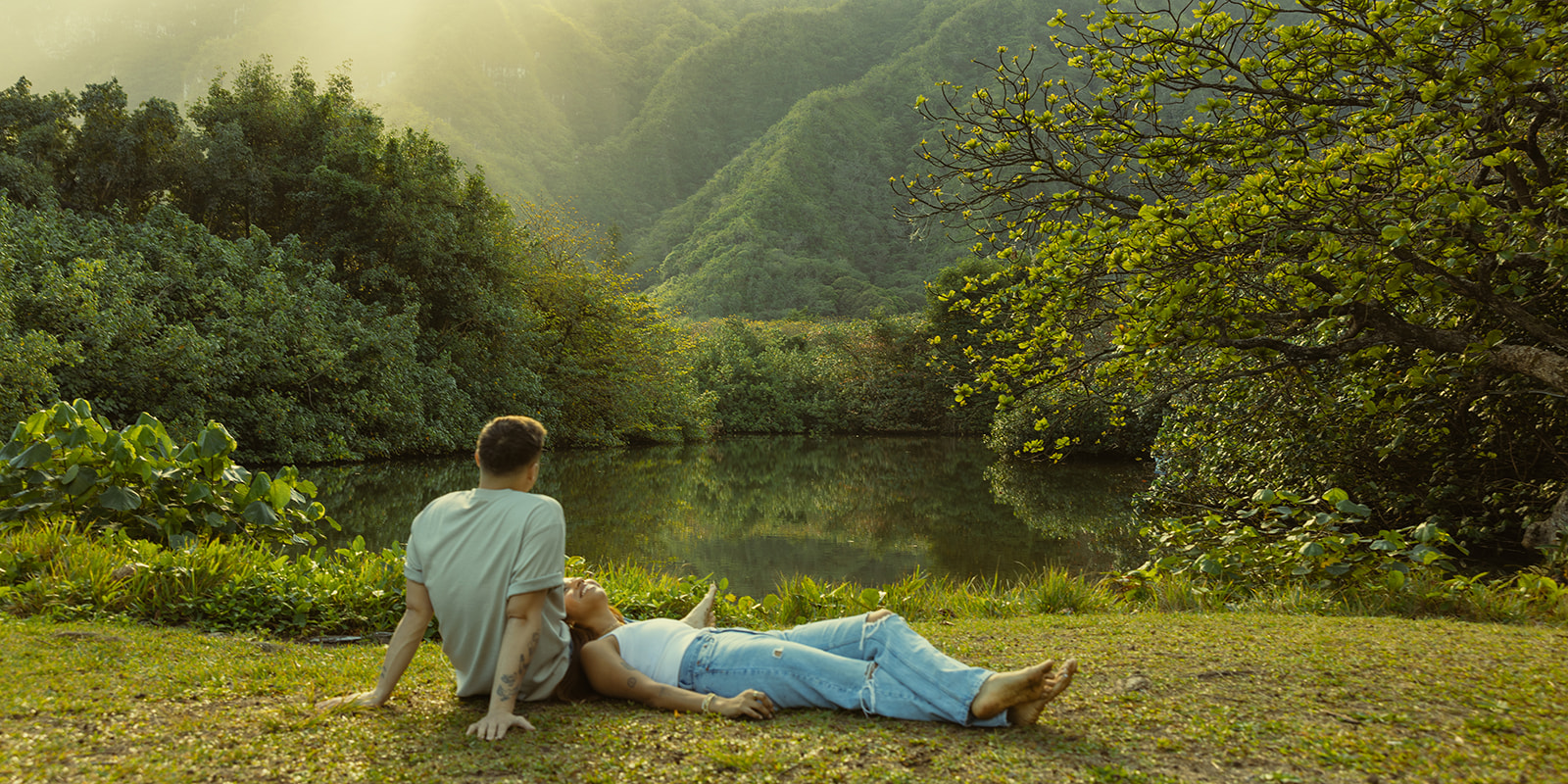 Lush Lakeside Mountains Oahu Hawaii Engagement Pictures Laying Couple North Shore