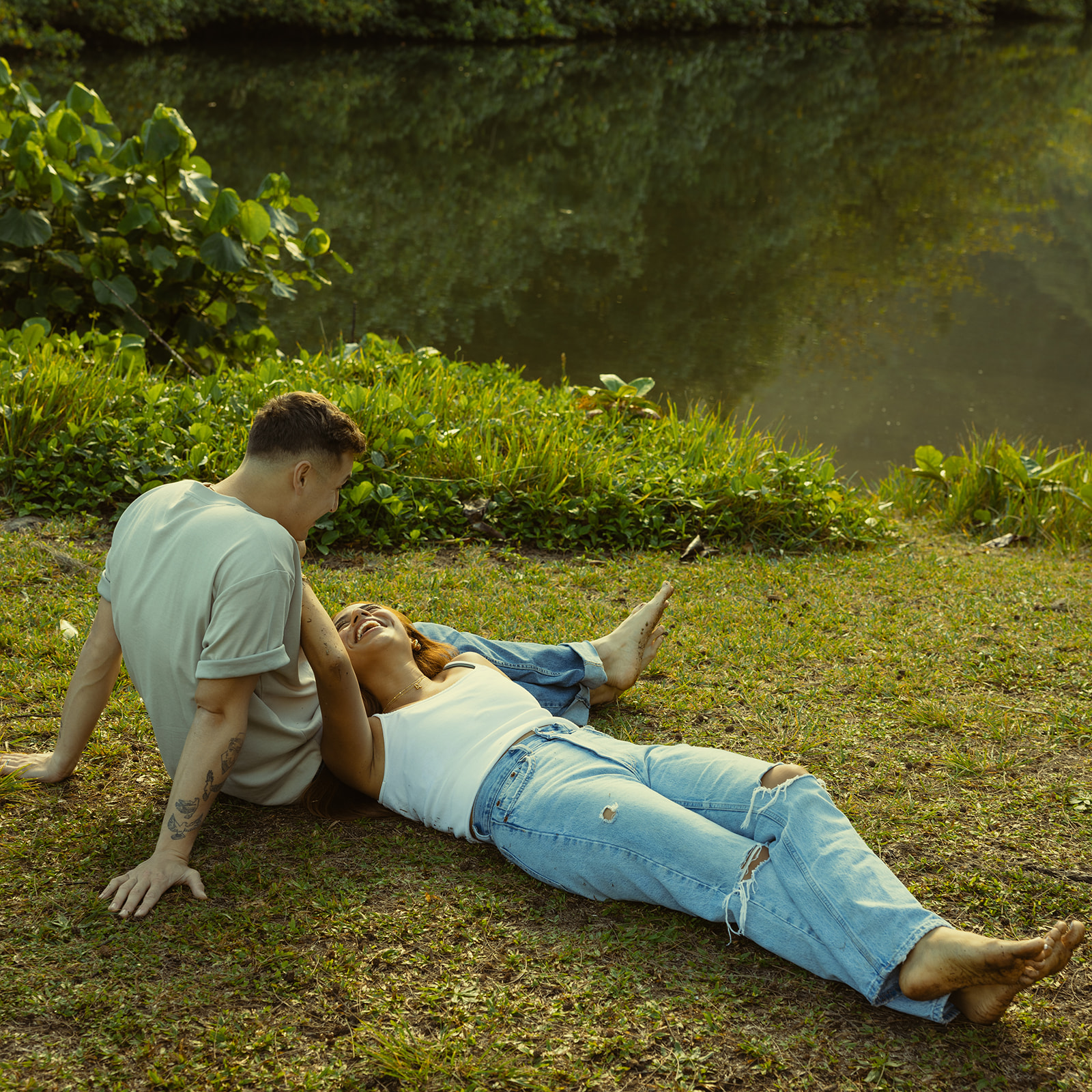 Lush Lakeside Mountains Oahu Hawaii Engagement Pictures Laying Couple North Shore