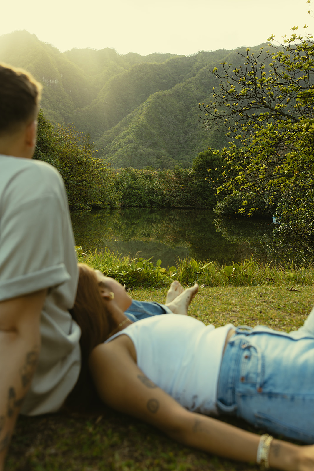 Lush Lakeside Mountains Oahu Hawaii Engagement Pictures Laying Couple North Shore