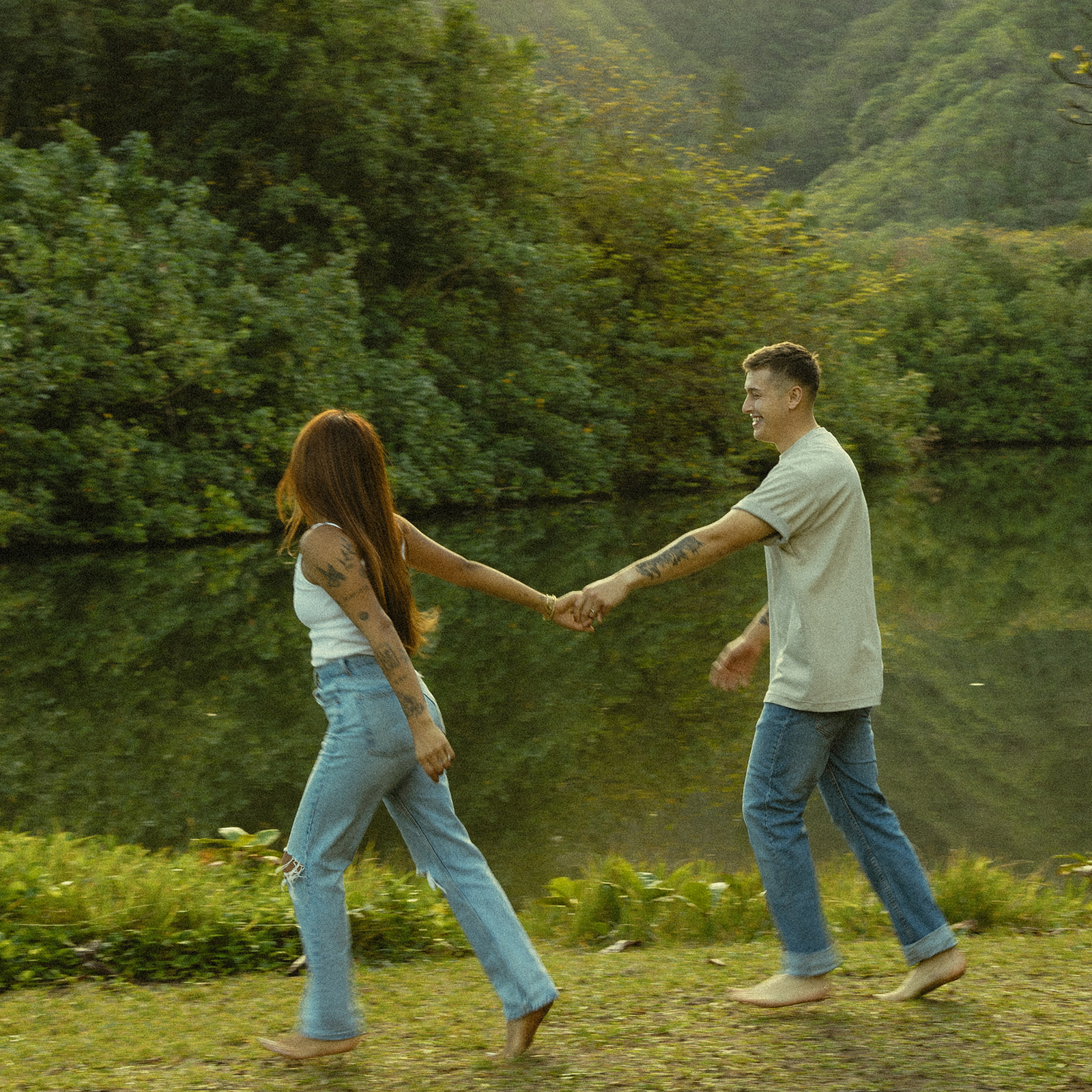 Lush Lakeside Mountains Oahu Hawaii Engagement Pictures Running Turning Couple North Shore