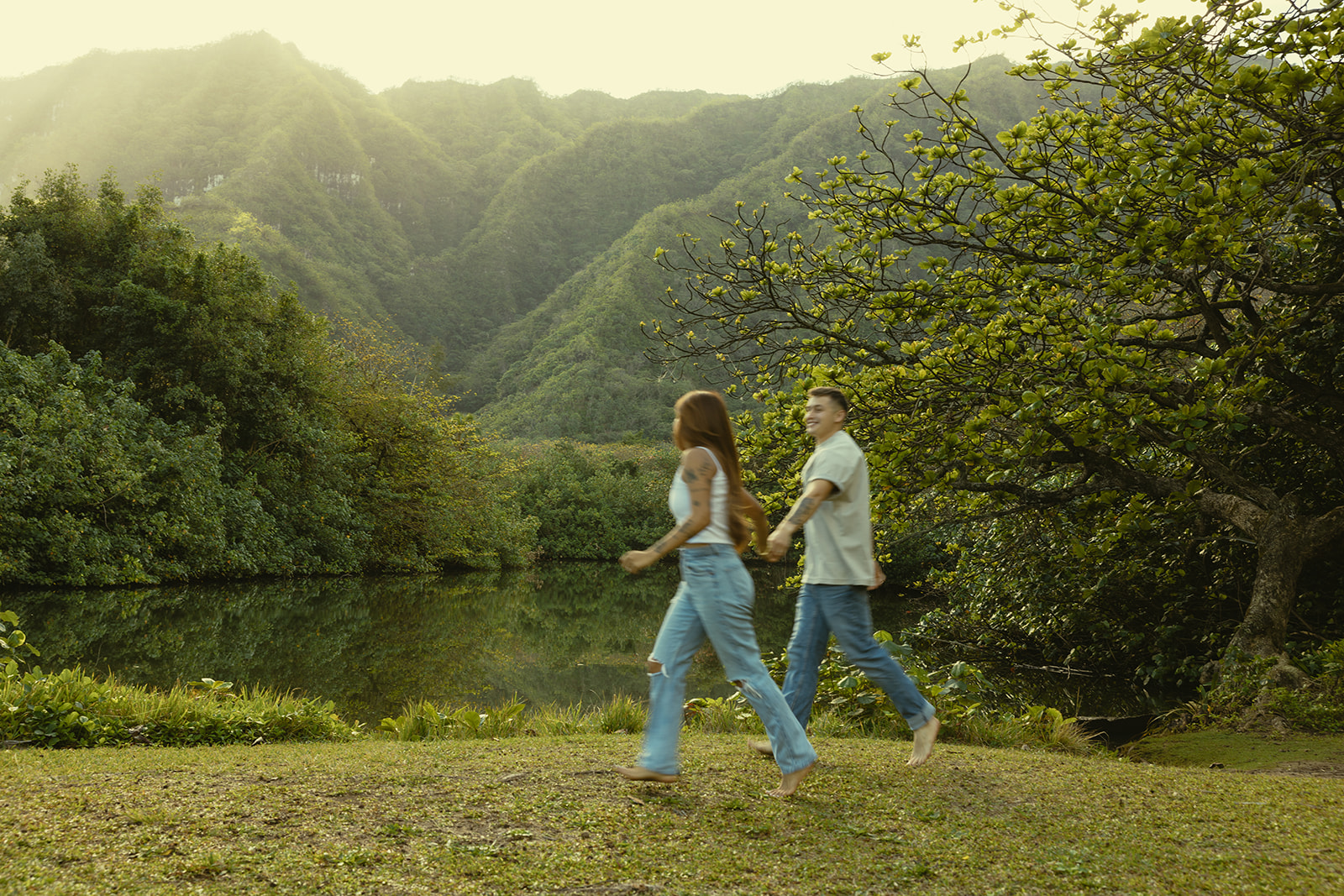 Lush Lakeside Mountains Oahu Hawaii Engagement Pictures Running Couple North Shore