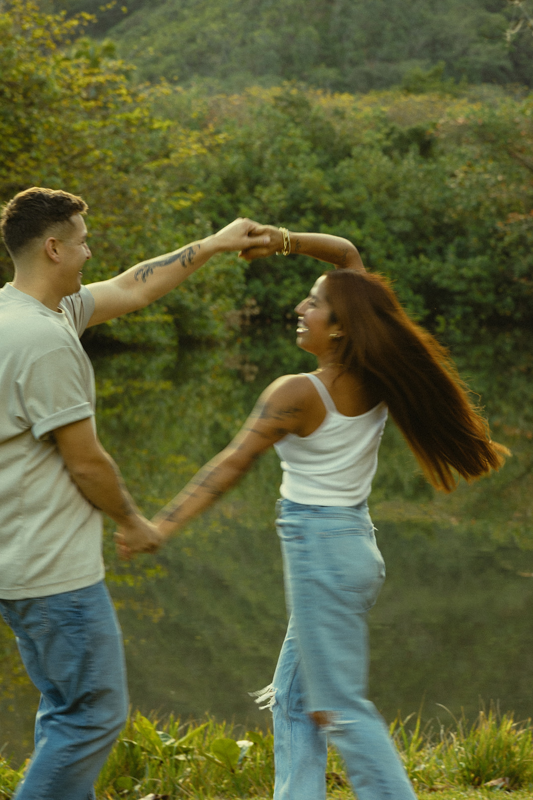 Lush Lakeside Mountains Oahu Hawaii Engagement Pictures Twirling Turning Couple North Shore