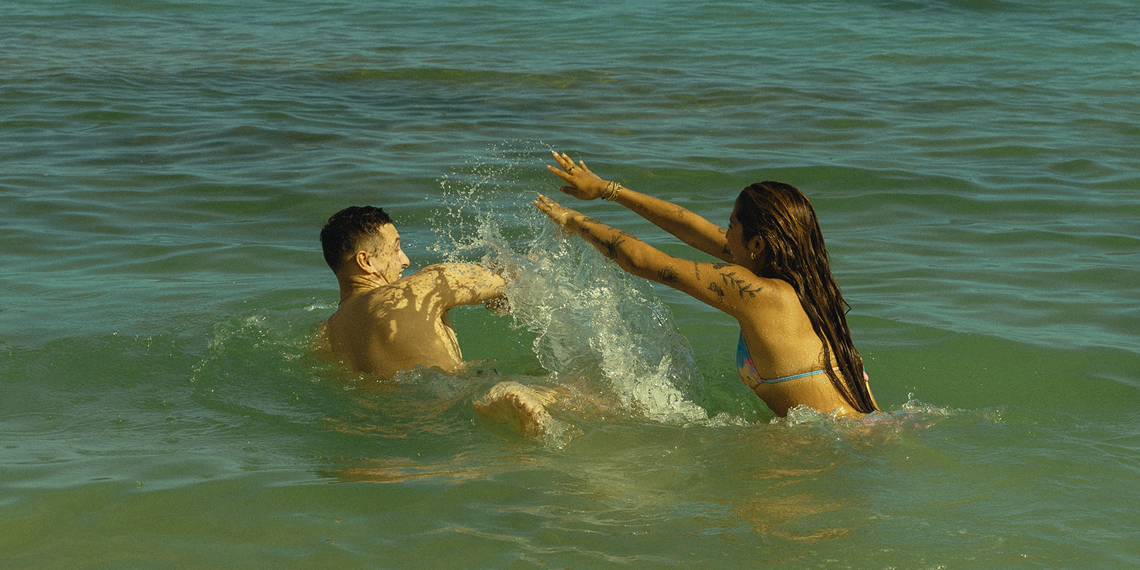 Backdrop Playing in Water in Beach North Shore Oahu Hawaii Adventure Couple Pictures