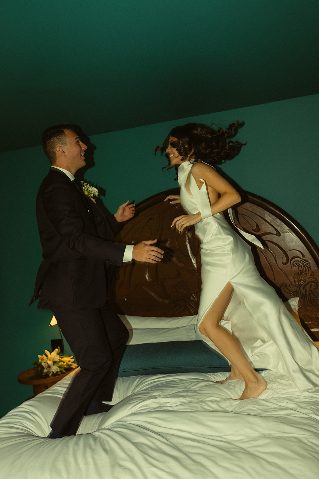 Fun Bride and Groom Wedding Portraits at Mayfair Hotel & Garden Coconut Grove Jumping on bed