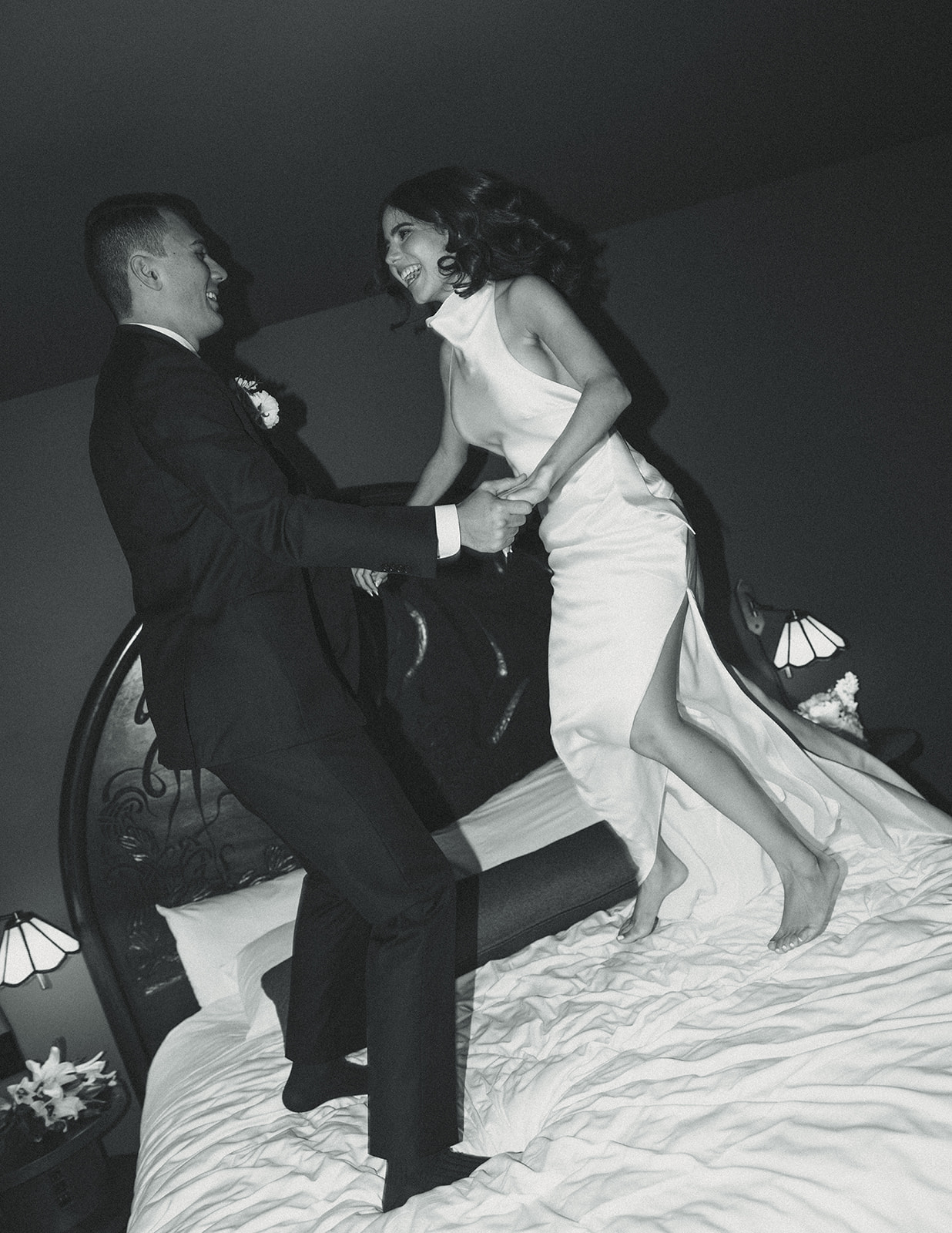 Fun Bride and Groom Wedding Portraits at Mayfair Hotel & Garden Coconut Grove Jumping on bed B&W