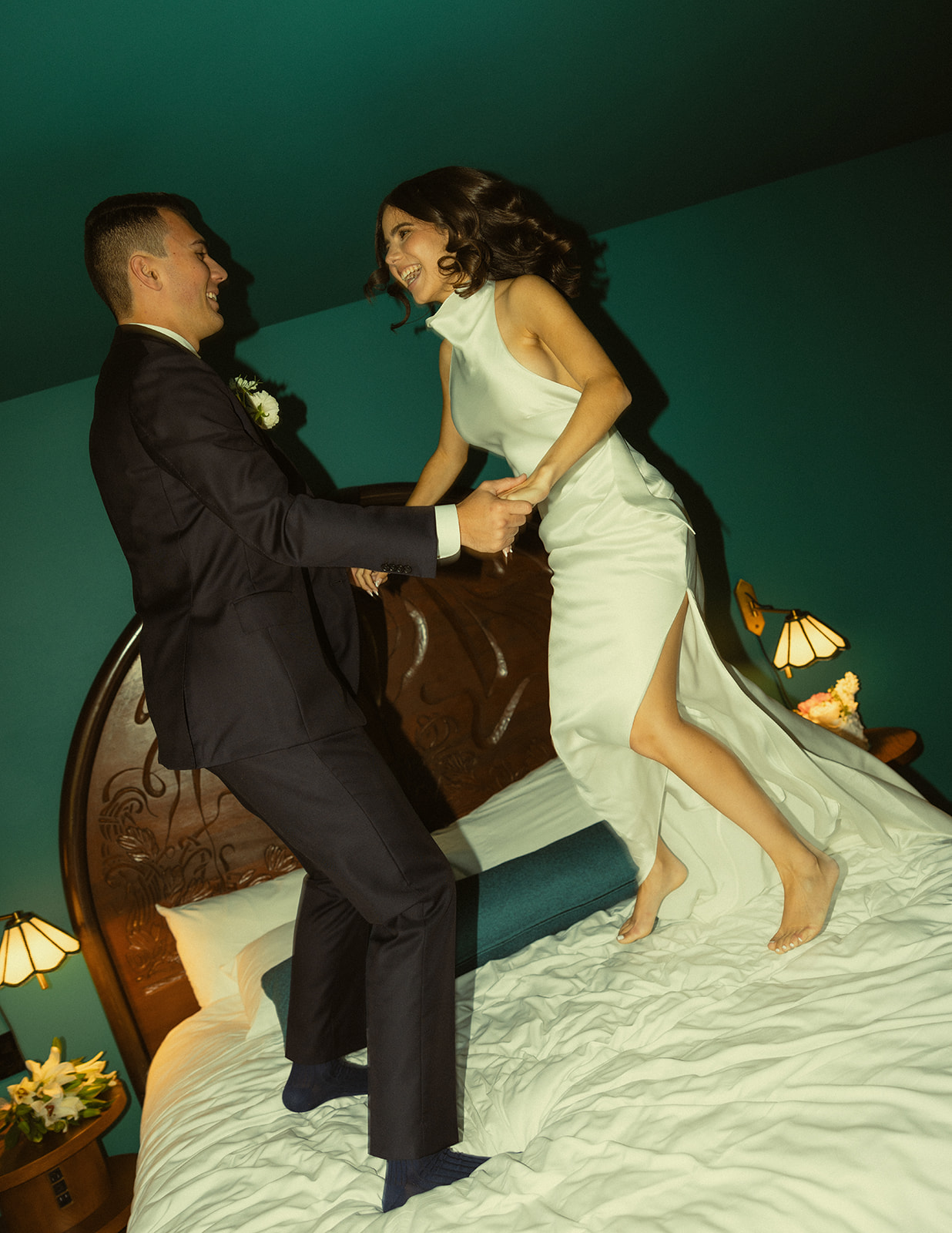 Fun Bride and Groom Wedding Portraits at Mayfair Hotel & Garden Coconut Grove Jumping on bed