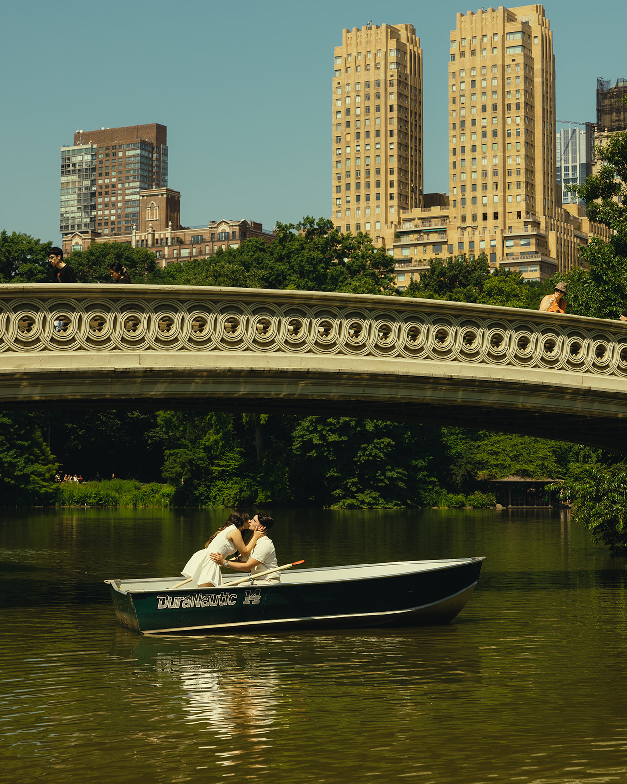 New York City Central Park Central Park Canoe Couples Session Kissing Couple in front of bows bridge