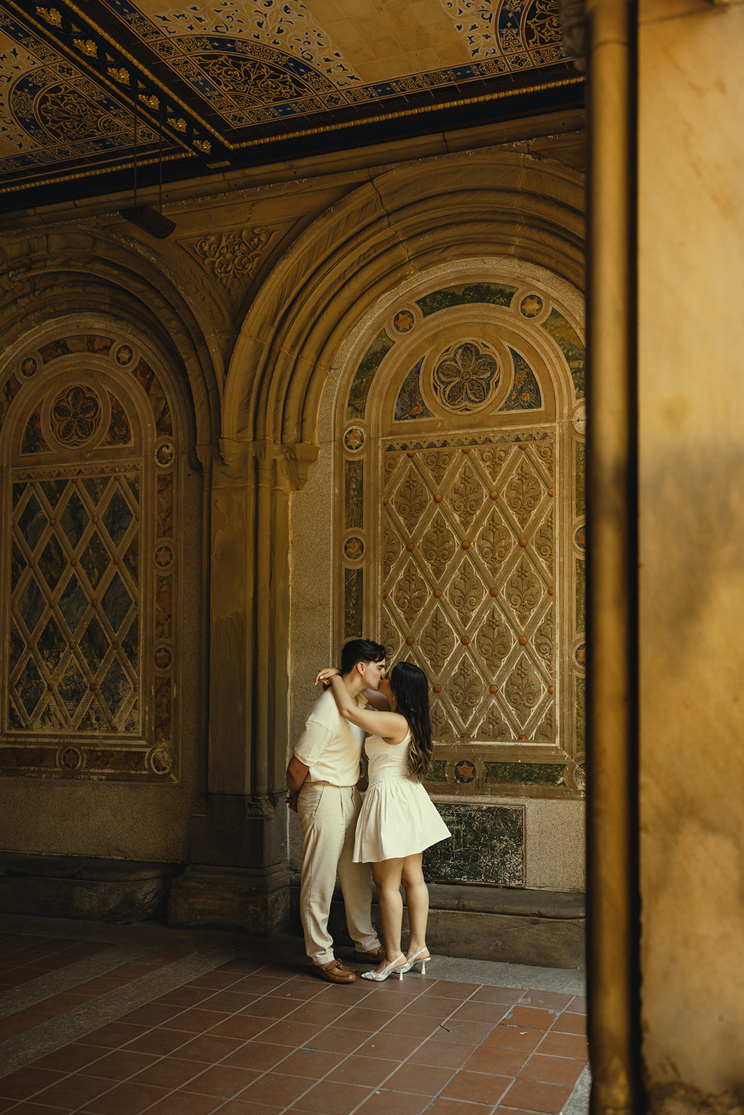 Documentary Engagement Photos of Kissing Couple, underneath the Bethesda Terrace Arcade inn Central Park New York