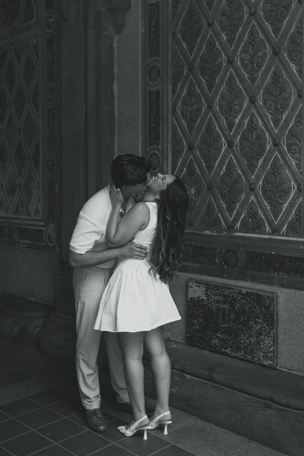 Documentary Engagement Photos of Kissing Couple, underneath the Bethesda Terrace Arcade inn Central Park New York in Black and White