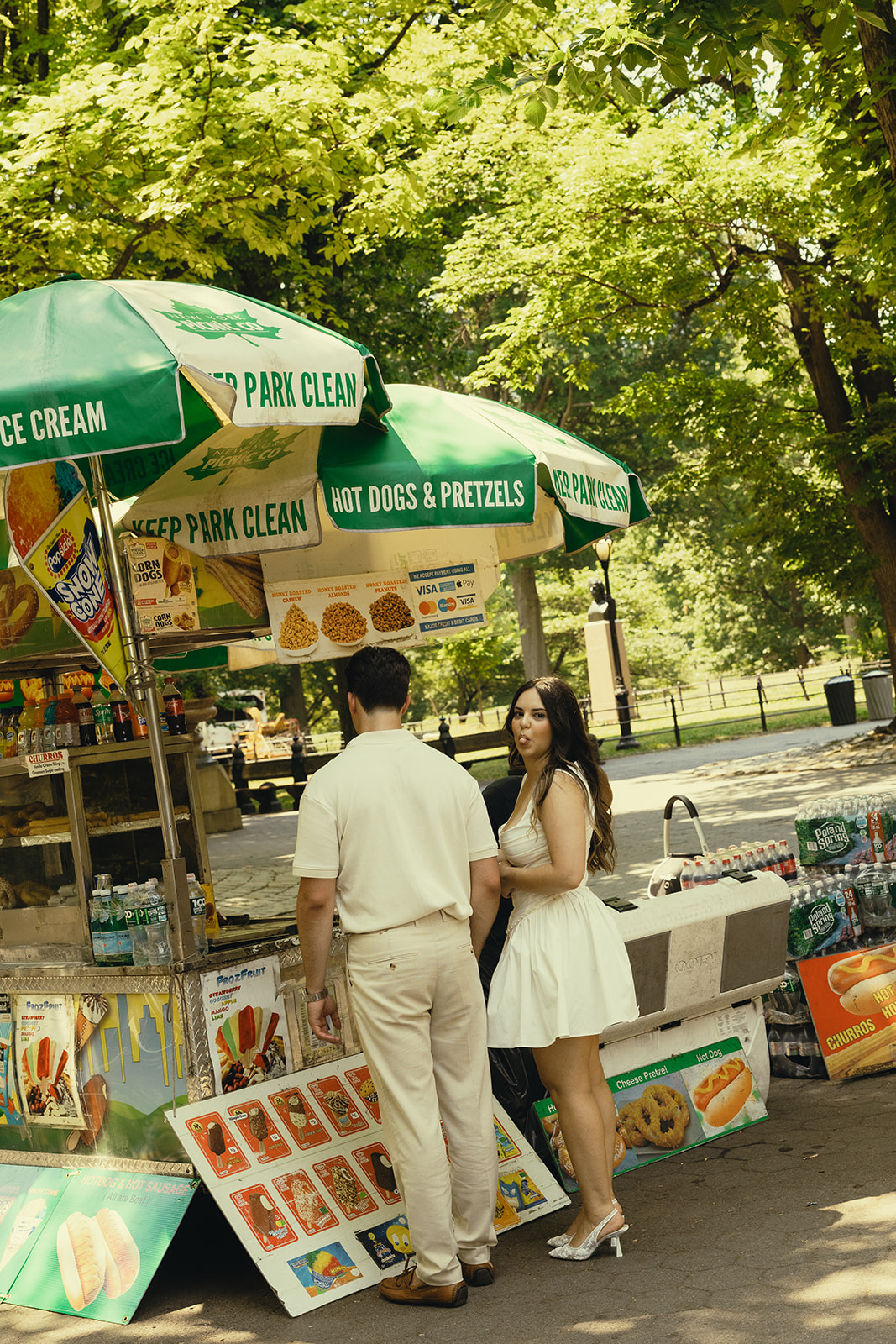 Fun Playful Engagement Photos in Central Park Grabbing Ice Cream Fruit Bars in New York during the Fall