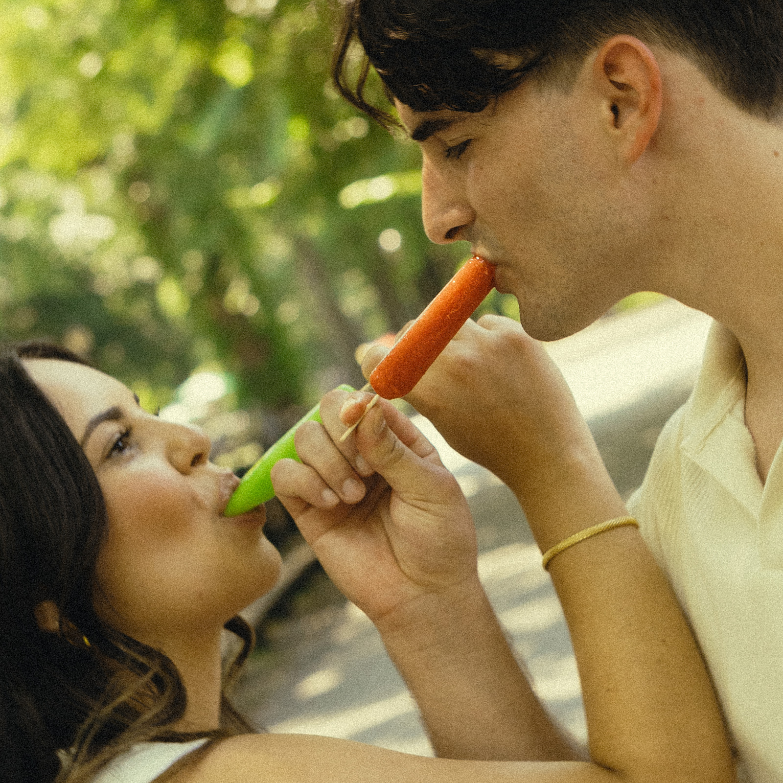 Fun Playful Engagement Photos in Central Park Eating Ice Cream Fruit Bars in New York during the Fall