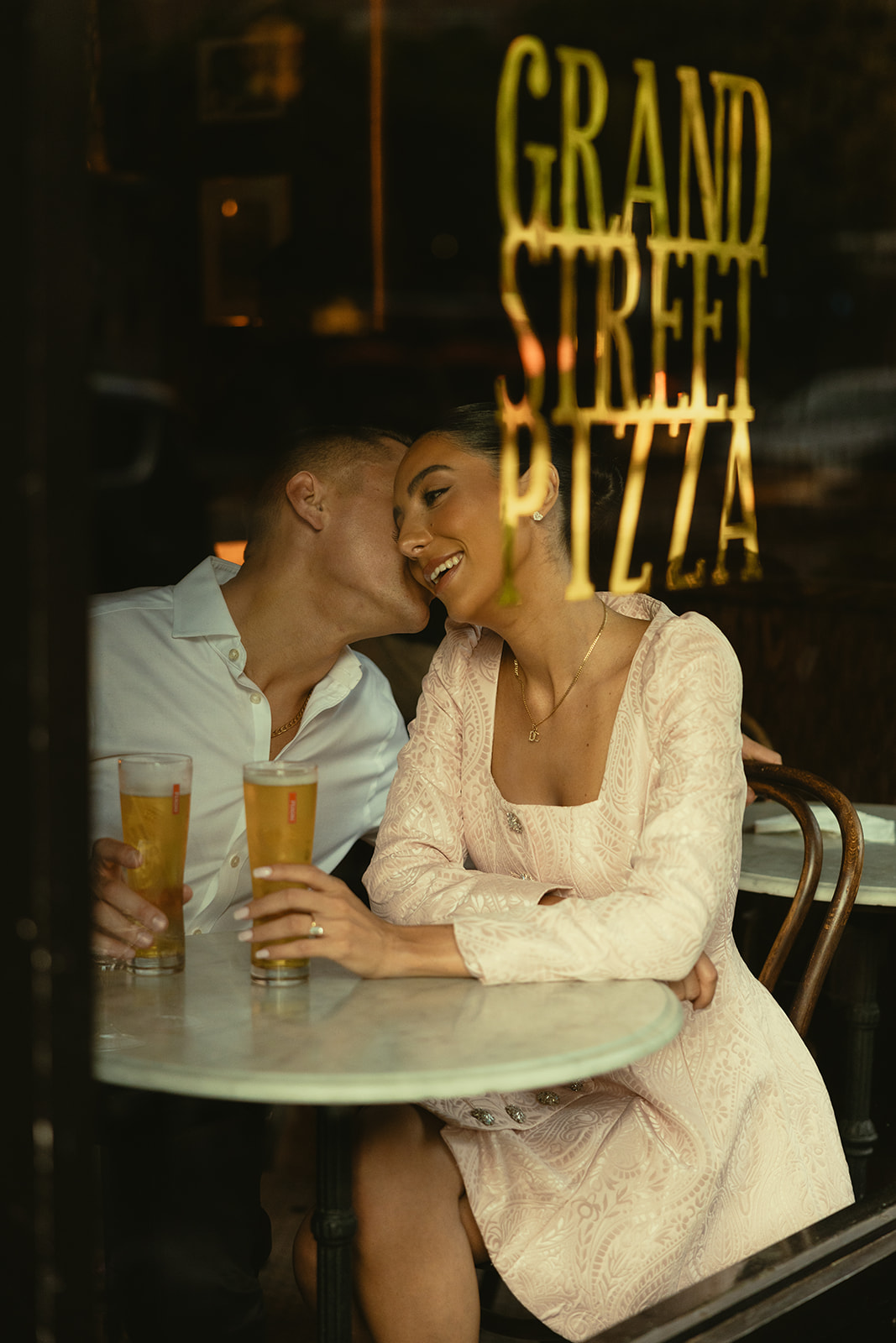 Sweet and documentary engagement photos in new york city at pizza shop with beer