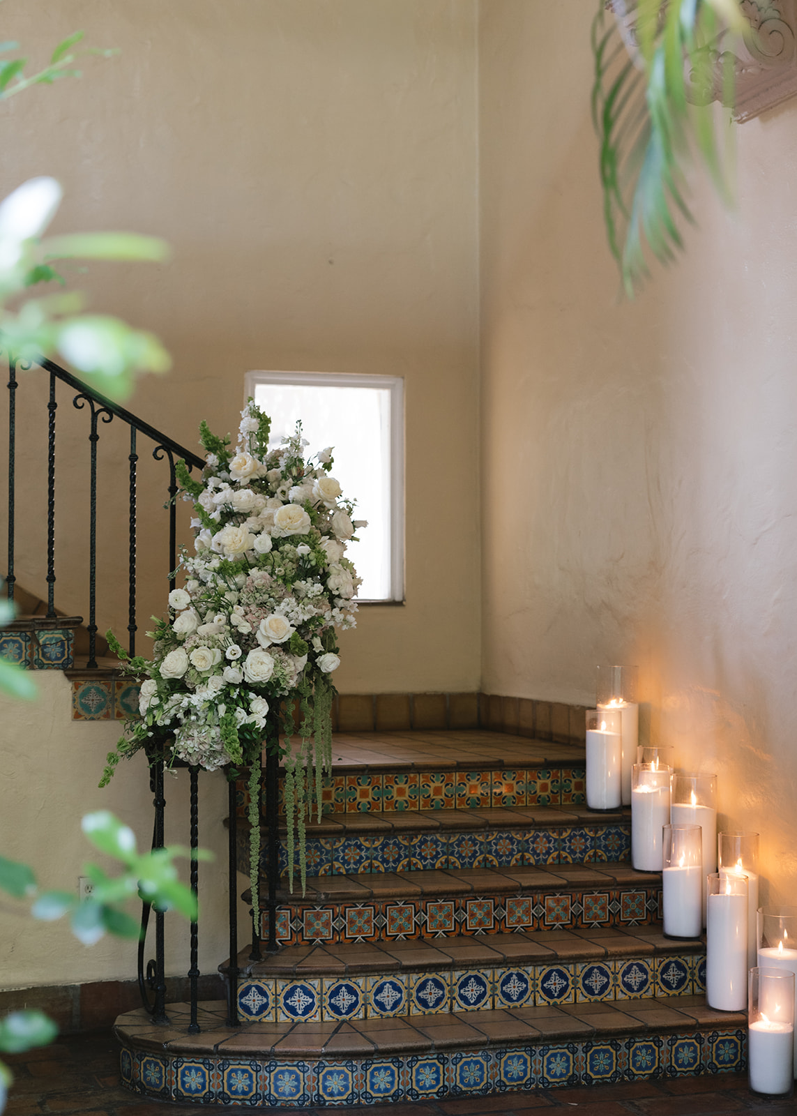 Sophisticated wedding venue design from a luxurious New York City wedding day, featuring a luxury floral and candlelight installation on a grand staircase for a timeless celebration.