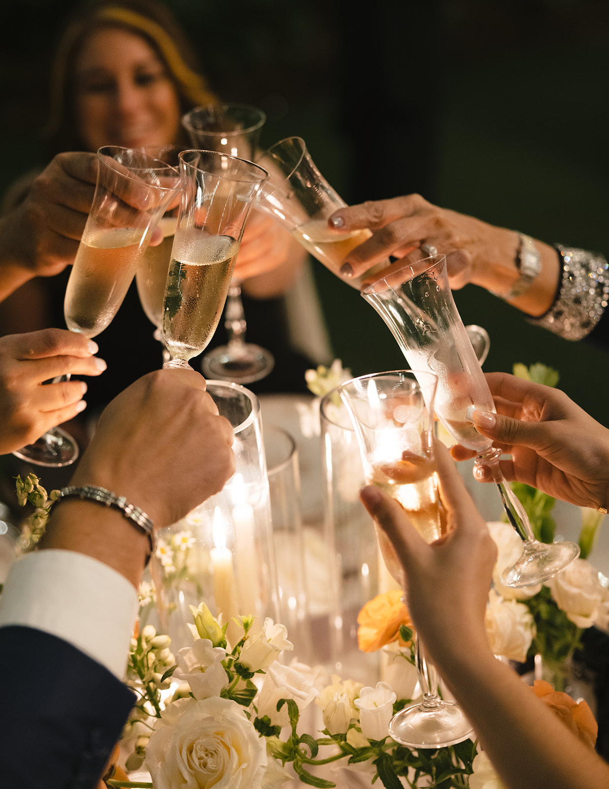 An intimate moment from a luxurious New York City wedding day, showing guests celebrating with a champagne toast at a luxury destination wedding reception.